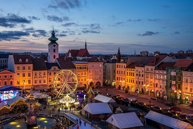 European city square decorated with Christmas lights and a festive tree