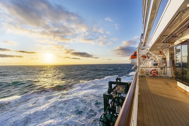 Traveller planning a Christmas fjord cruise with a map and winter clothing