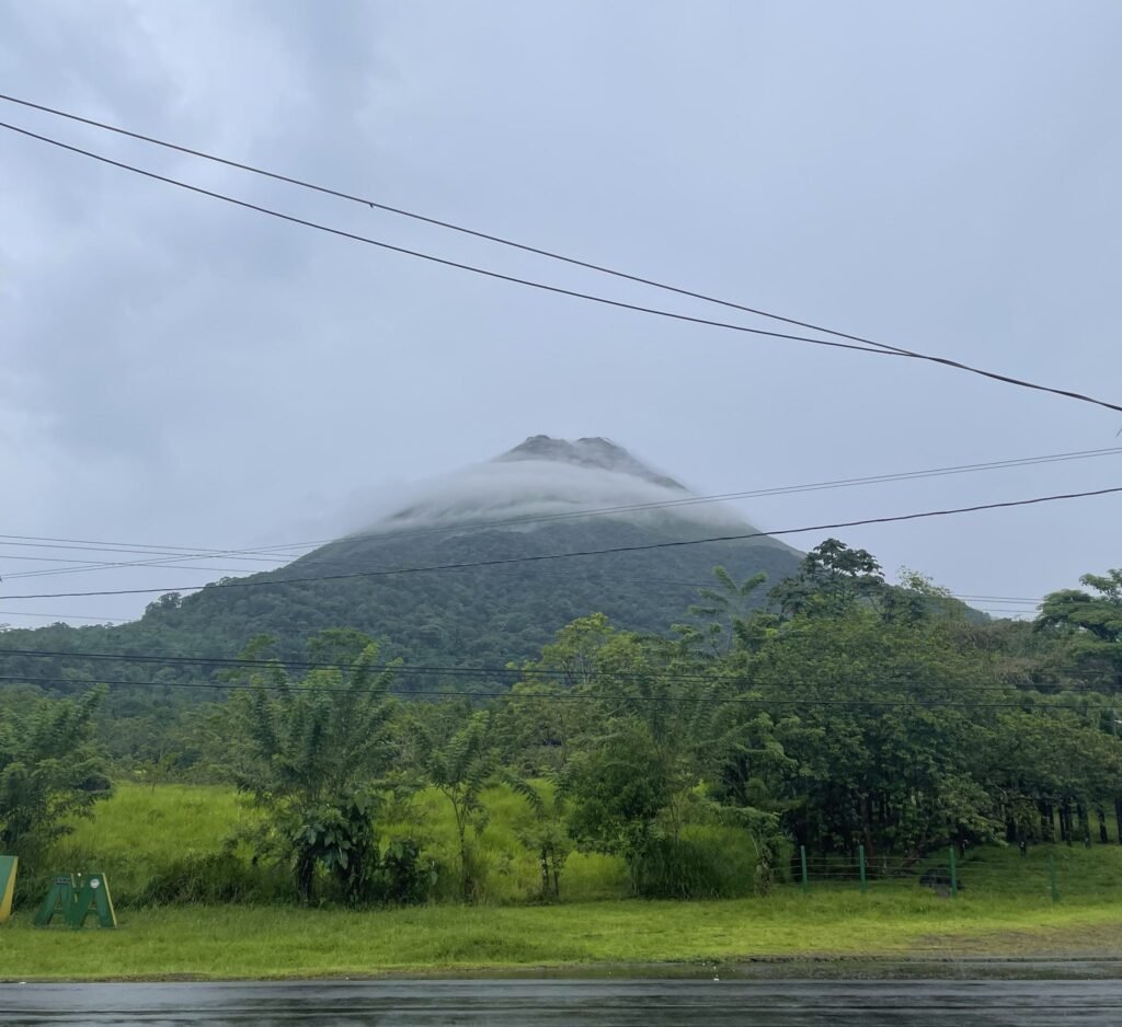 The cone of Arenal Volcano rising above rainforest in Costa Rica
