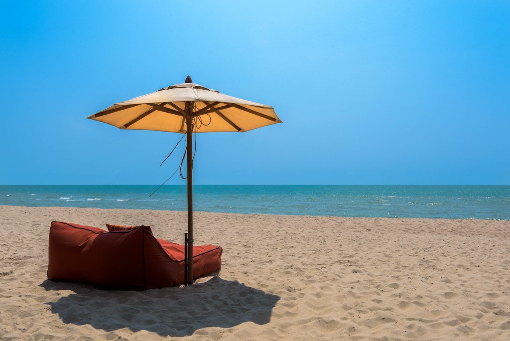 Quiet sandy beach and calm sea at Cha Am in Thailand